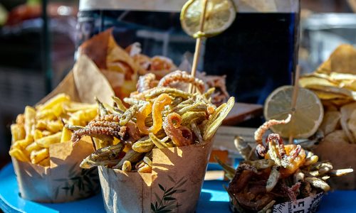 Street food of the city of Palermo in Sicily city with Norman Arab influence. Mixed fried small fish and chips, sold in street stalls.