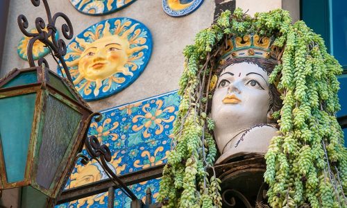 Ornamental flowered pottery planter in a balcony along the streets of Taormina, Eastsicily