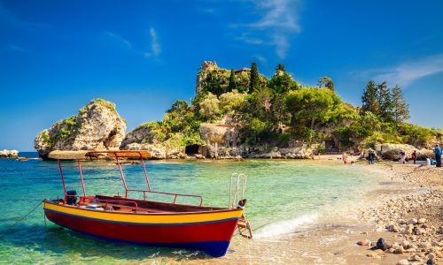 small boat for excursion in front of the island Isola Bella at Taormina, Sicily